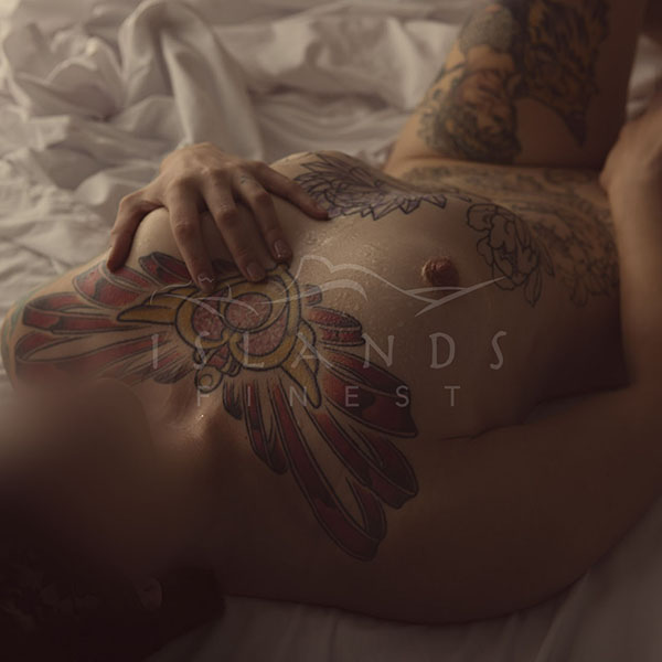 Livianna kneeling on a bed