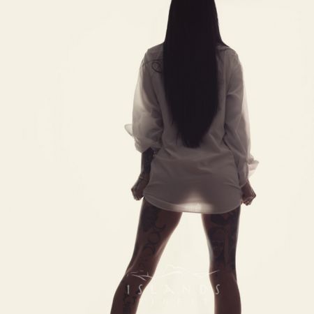 Victoria escort @ Island's Finest Lexx in a white see through shirt with the light shining between her legs showing her sexy shape